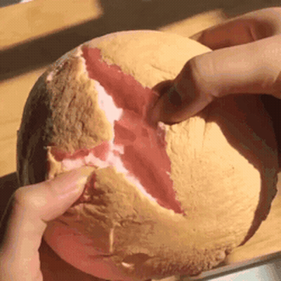 Person Holding Melon With Slice Taken Out GIF