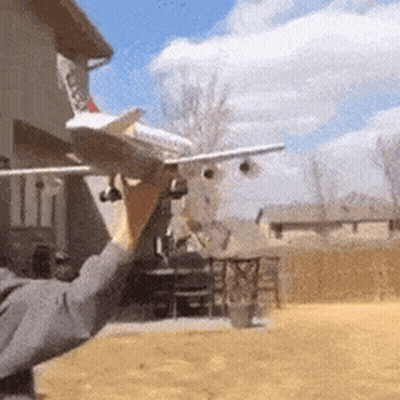 Person Holding Model Airplane GIF