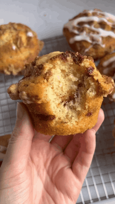 Person Holding Muffin With Bite Taken Out GIF