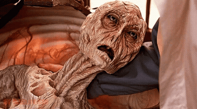 Person Holding Mummy With Scared Look GIF