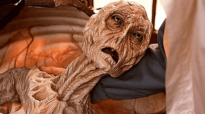 Person Holding Mummy With Very Long Neck GIF