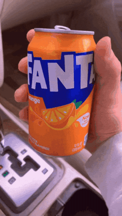 Person Holding Orange Fanta Can GIF