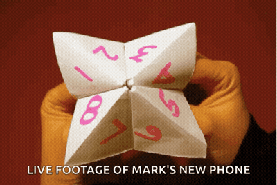 Person Holding Paper Fortune Teller With Live Footage Of Mark's New Phone GIF