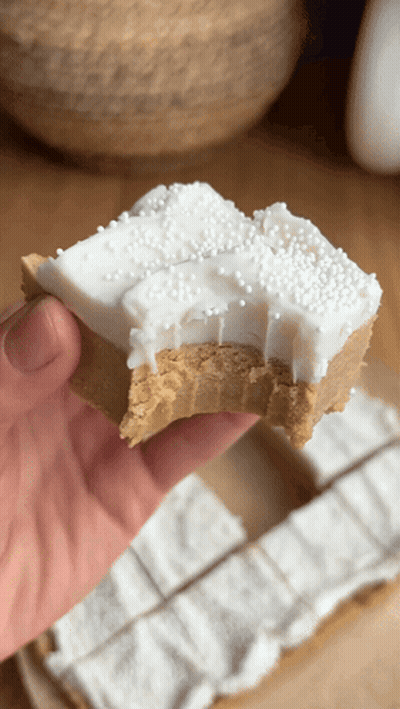 Person Holding Peanut Butter Fudge With White Frosting Sprinkles GIF