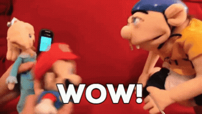 Person Holding Phone Beside Mario Puppet Wow GIF
