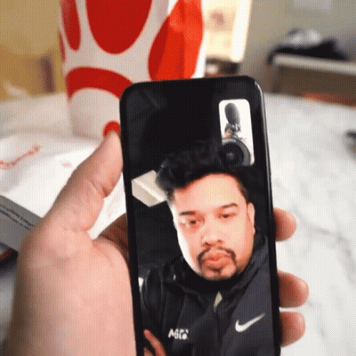 Person Holding Phone With Man On Screen GIF