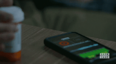 Person Holding Pills In Front Of Show Case Logo GIF