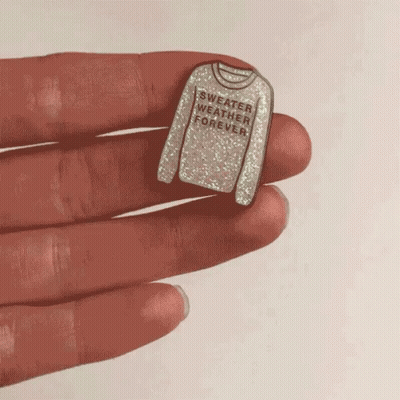Person Holding Pin Saying Sweater Weather Forever GIF