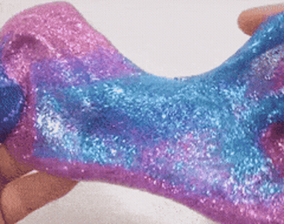 Person Holding Pink And Blue Slime With Glitter GIF