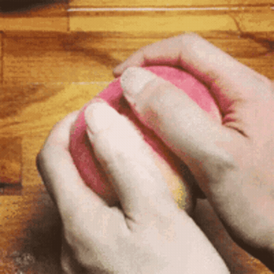 Person Holding Pink Ball GIF