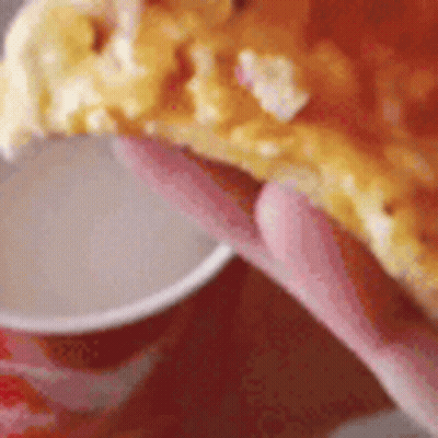 Person Holding Pizza Slice Next To Sauce Cup GIF