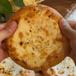 Person Holding Pizza With Bite GIF