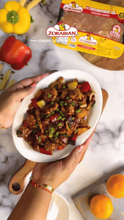 Person Holding Plate Of Food Next To Zorabian Chicken GIF