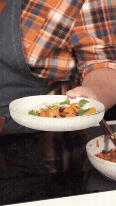 Person Holding Plate Of Food With Carrots And Rice GIF