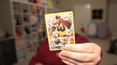 Person Holding Pokemon Card With Yellow Pokemon GIF