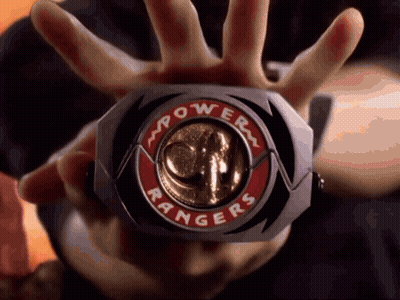 Person Holding Power Rangers Badge GIF