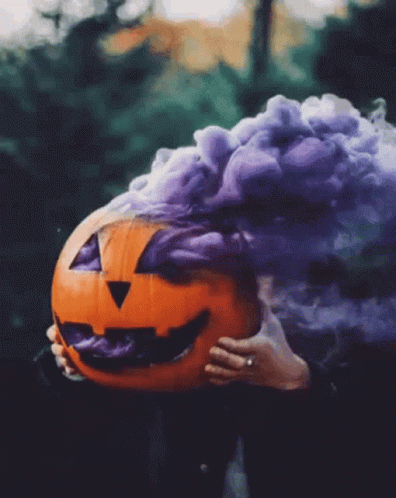 Person Holding Pumpkin With Purple Smoke GIF