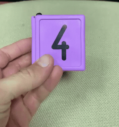 Person Holding Purple Item With Number Four GIF