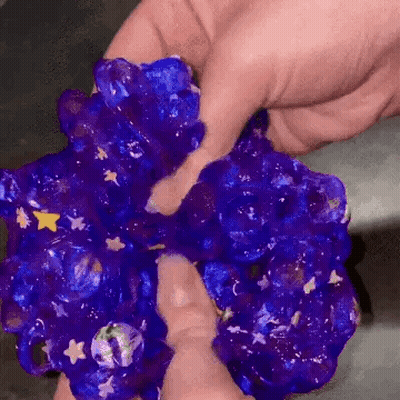 Person Holding Purple Slime With Stars GIF