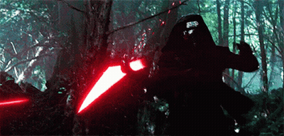 Person Holding Red Light Saber In Forest GIF