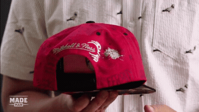 Person Holding Red Mitchell & Ness Hat GIF