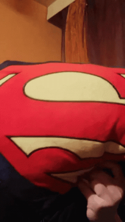 Person Holding Red Superman Pillow GIF