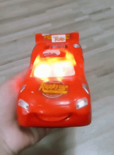 Person Holding Red Toy Car Saying Lightning McQueen GIF