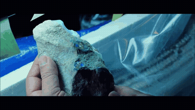 Person Holding Rock With Plastic Bag GIF
