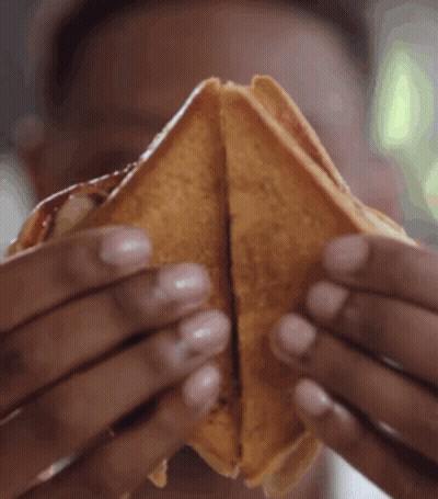 Person Holding Sandwich Halves GIF