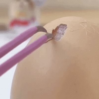 Person Holding Screwdriver At Hole In Concrete Wall GIF