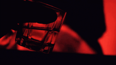 Person Holding Shot Glass With Red Light GIF
