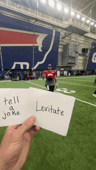Person Holding Sign Saying Tell A Joke And Levitate GIF