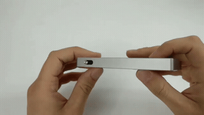Person Holding Silver Object With Small Hole GIF