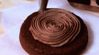 Person Holding Slice Of Cornbread With Witches GIF