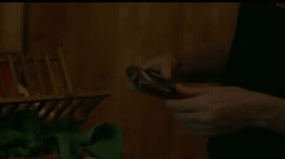 Person Holding Small Device With Pink Screen GIF