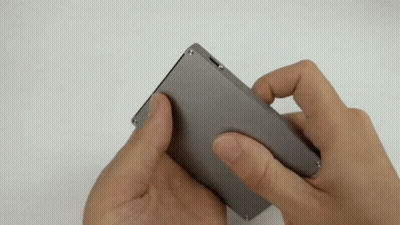 Person Holding Small Gray Object GIF