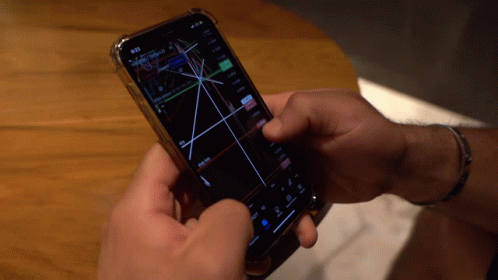 Person Holding Smart Phone With Graph GIF