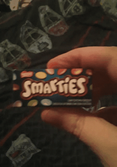 Person Holding Smarties Box GIF