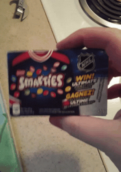 Person Holding Smarties Candy GIF
