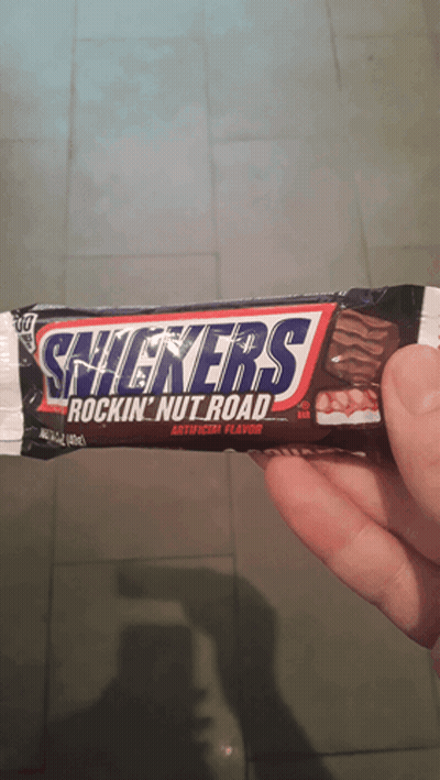 Person Holding Snickers Rockin Nut Road Bar GIF