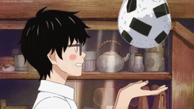 Person Holding Soccer Ball In Front Of Shelf GIF