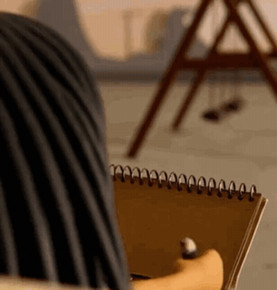 Person Holding Spiral Notebook And Pen GIF