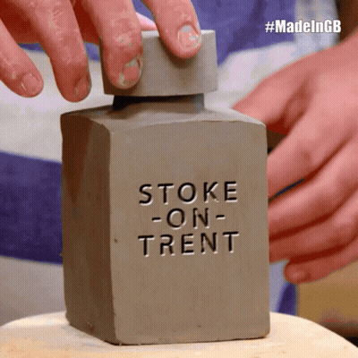 Person Holding Stoke-on-Trent Bottle
