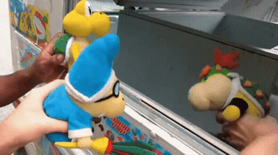 Person Holding Stuffed Animal At Ice Cream Head Machine GIF