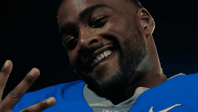 Person Holding Stuffed Animal In Front Of Sign Saying S GIF