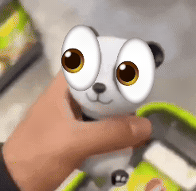 Person Holding Stuffed Animal With Big Yellow Eyes GIF