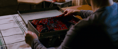 Person Holding Suitcase With Spider Man Suit GIF
