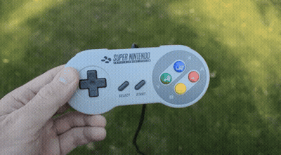 Person Holding Super Nintendo Controller GIF