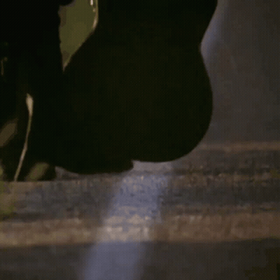 Person Holding Surfboard In Dark Room GIF