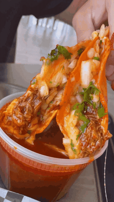 Person Holding Taco Over Sauce GIF